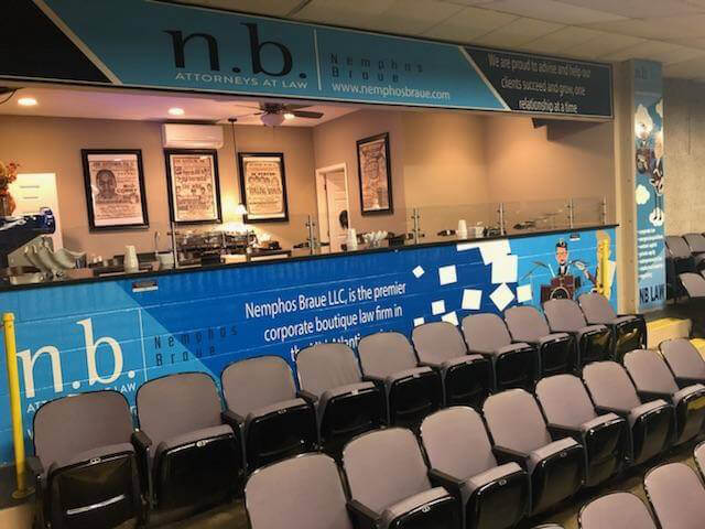 Image of chairs at a conference on Nemphos Braue's website
